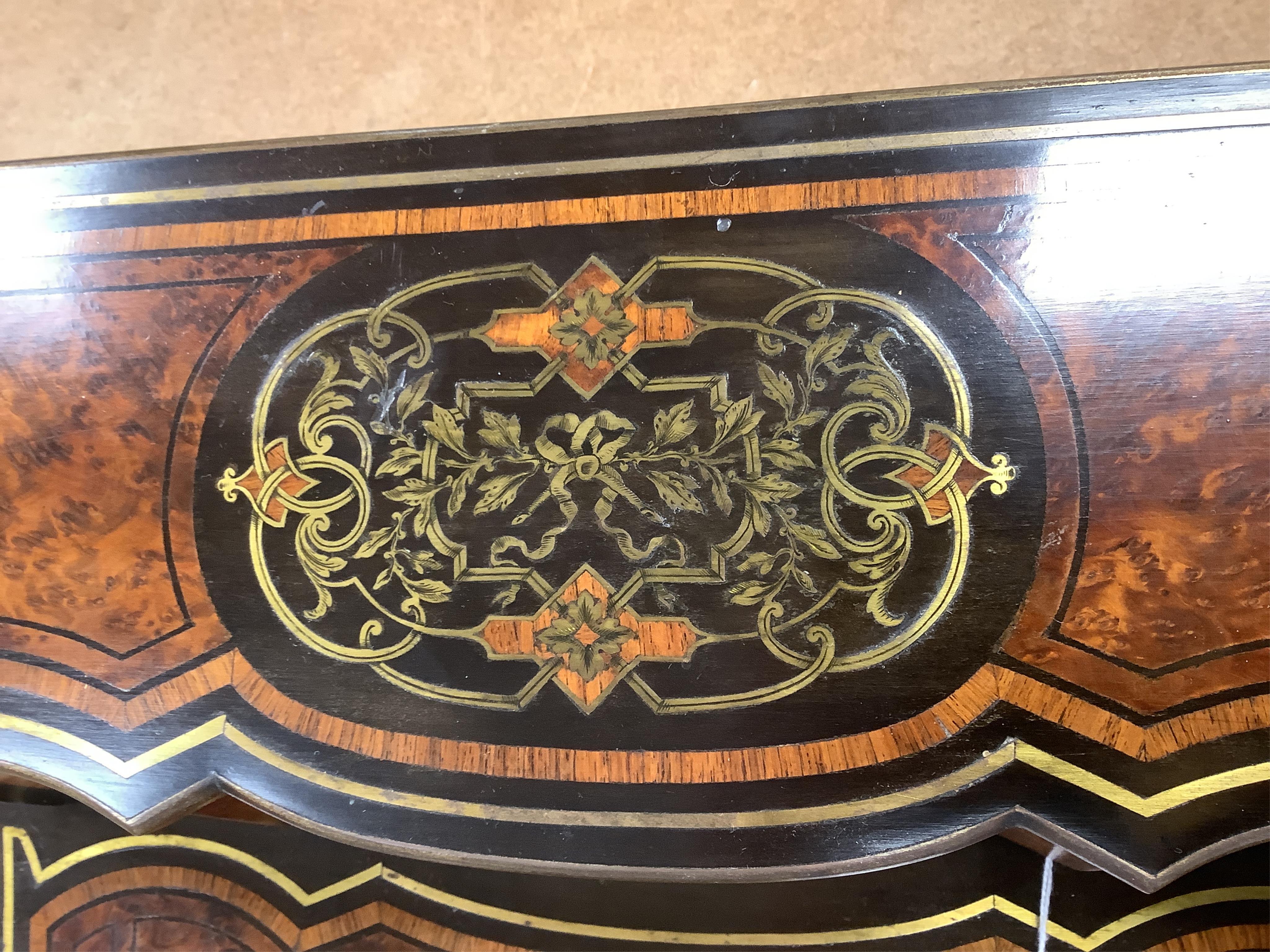 A 19th century French brass inlaid, tulip banded amboyna writing casket, the brass panel inscribed ‘Jane Lester’, 40cm wide